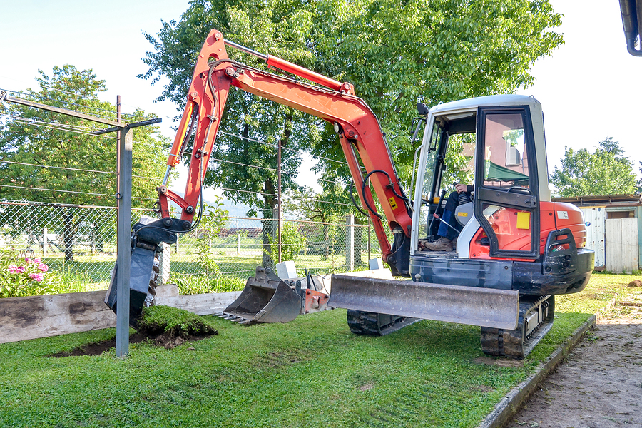 Digger digging for residential drain laying