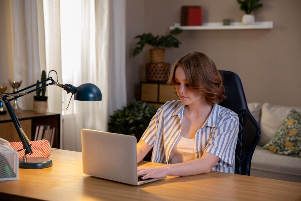 person sitting at desk using task lighting