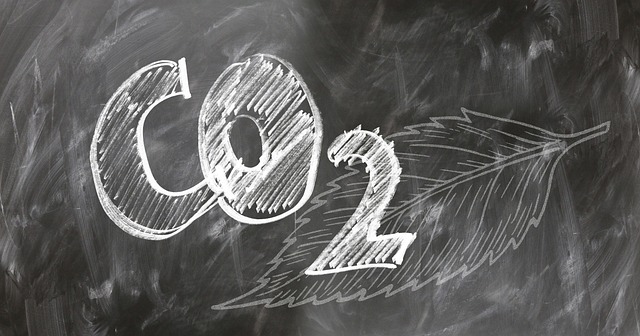 The chemical formula C O 2 written in chalk on a blackboard. 