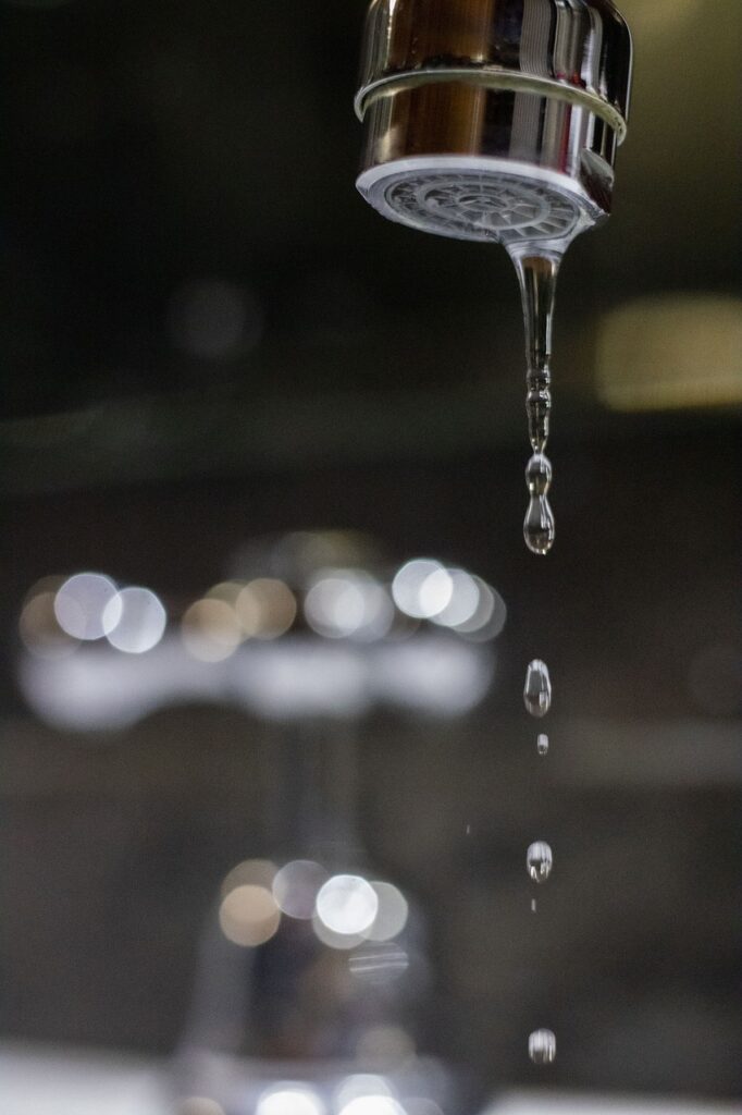 a tap with low pressure water coming from its hole/